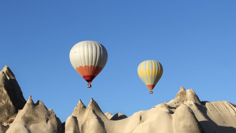 Kolorowe balony nad formacjami skalnymi Kapadocji o poranku